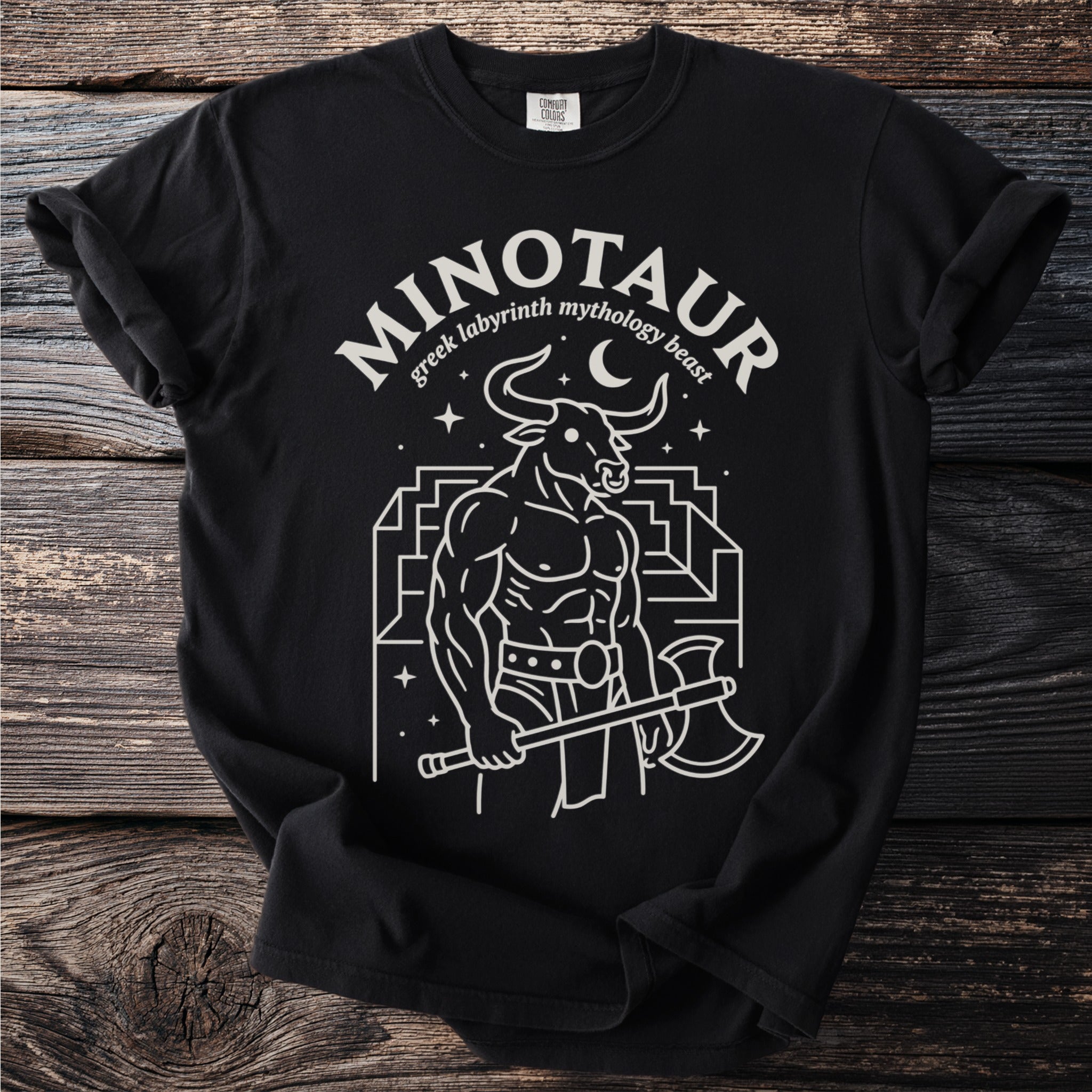 Black t-shirt with white line art of a minotaur holding an axe and the text "minotaur greek labyrinth mythology beast."