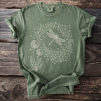 Green t-shirt with a white line drawing of a dragonfly and dandelions.