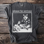 Dark grey t-shirt with "please be serious" text above a werewolf graphic.