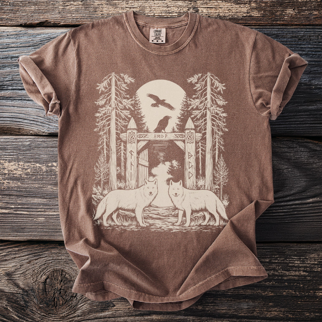 Brown t-shirt with woodland scene featuring two wolves and rune-decorated gate.
