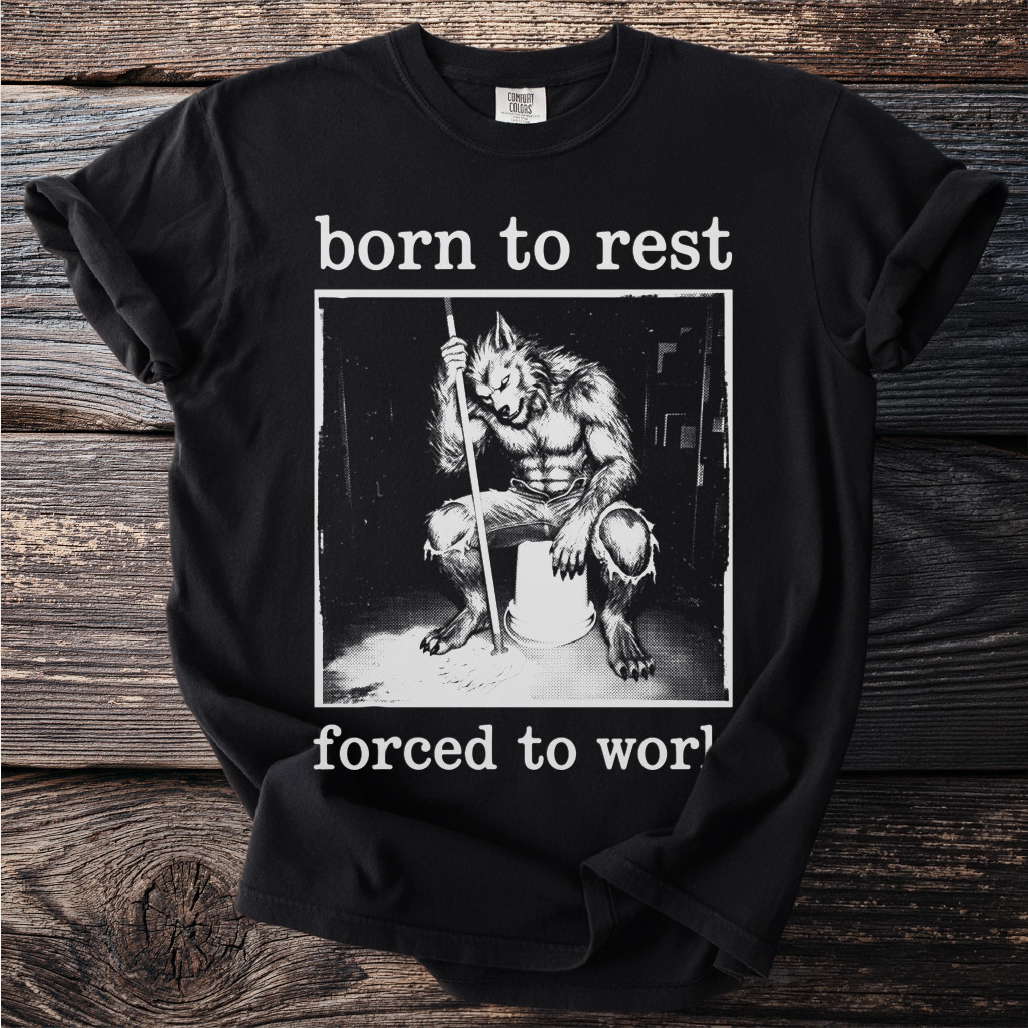 Black t-shirt with a werewolf mopping and the text "born to rest forced to work."