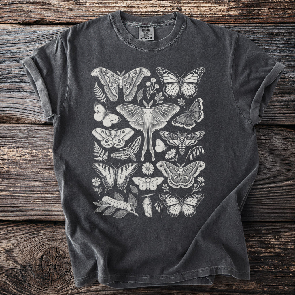 Dark grey t-shirt featuring a white line drawing of various moths, butterflies, and plants.