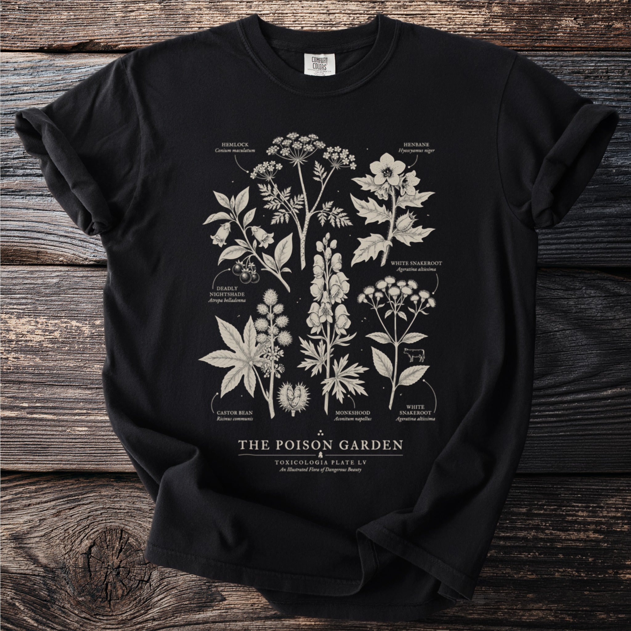 Black t-shirt featuring "The Poison Garden" illustration with toxic plants and scientific names.