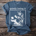 T-shirt with a wolf holding papers and a printer, text says "quietly losing it."