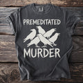 Dark gray t-shirt with white text "PREMEDITATED MURDER" and five white crows.
