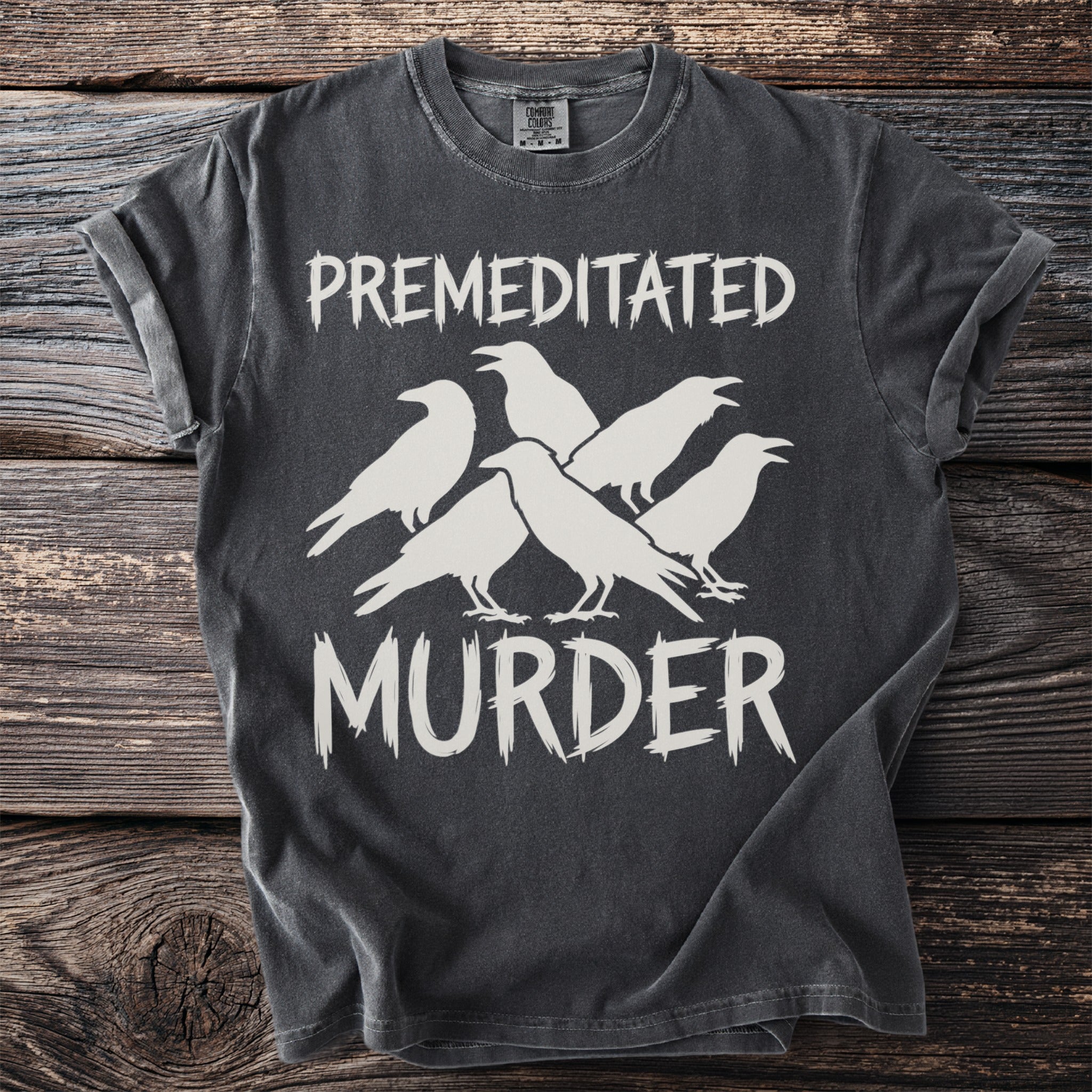 Dark gray t-shirt with white text "PREMEDITATED MURDER" and five white crows.