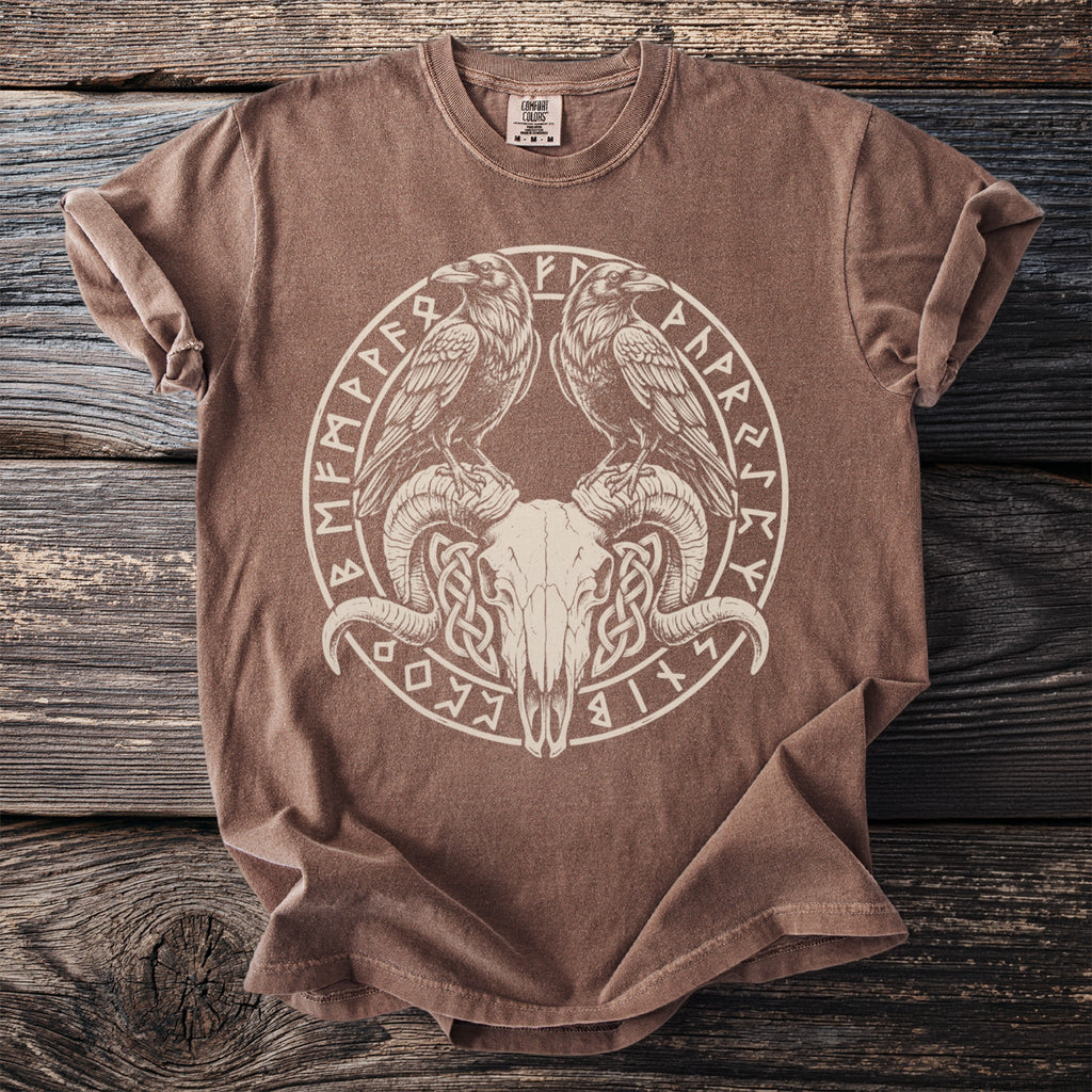 Brown t-shirt with a circular design featuring ram skull, two ravens, and runes.