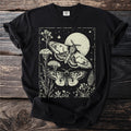 Black t-shirt with vintage-style moths and floral illustration on a starry night background.