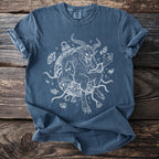 Blue t-shirt with a white line drawing of a horned demon entangled in chains and bells.