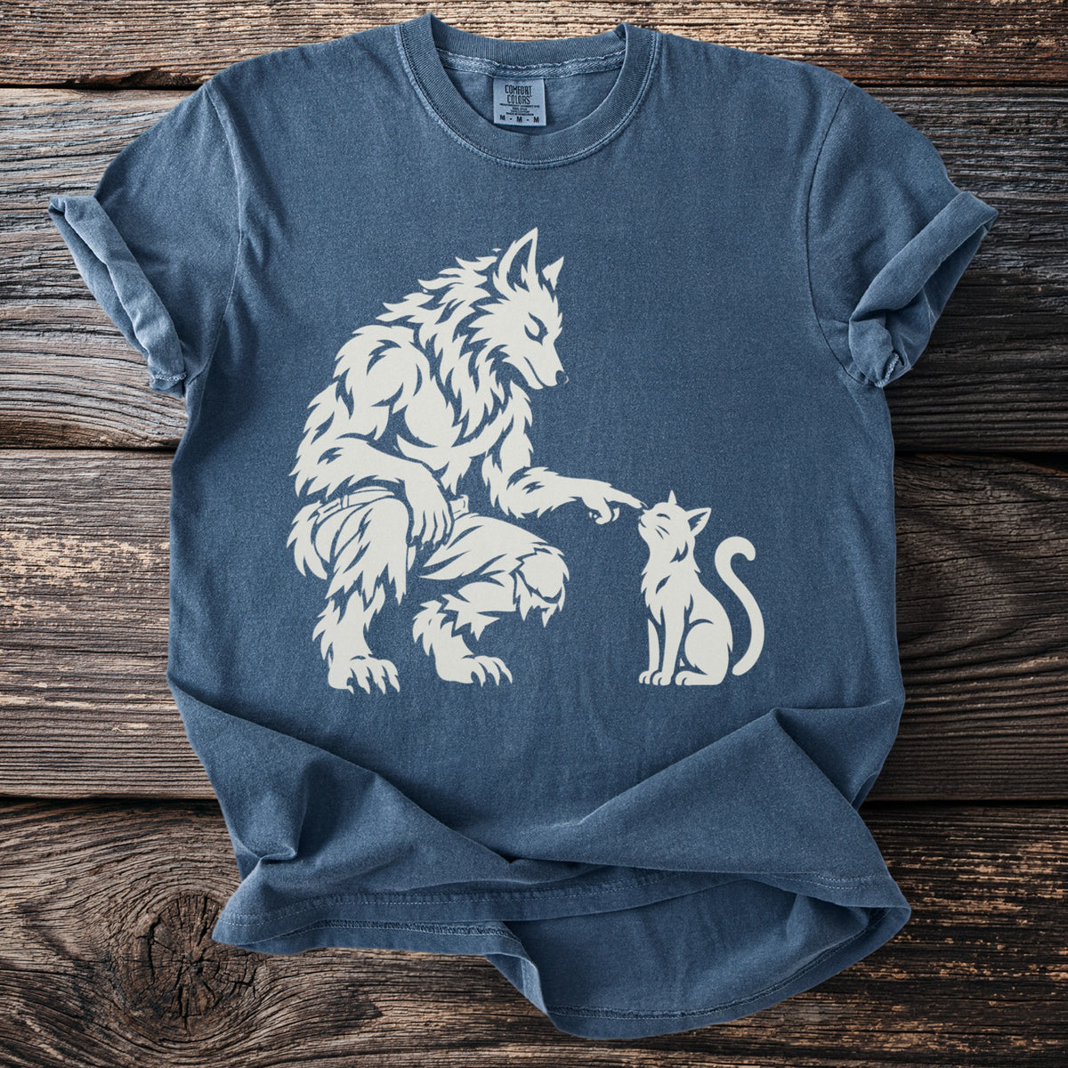 Werewolf gently touching a cat's nose on a blue t-shirt.