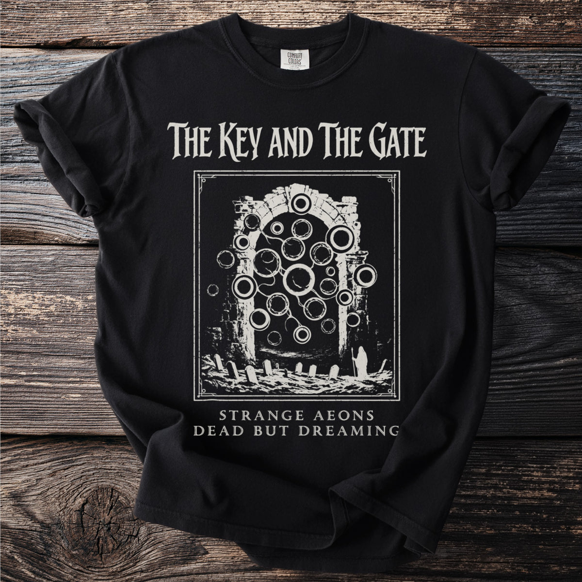 Black t-shirt with "The Key and The Gate" graphic and text "Strange Aeons Dead But Dreaming."