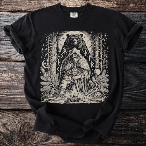 Black t-shirt with a linocut-style print of a Viking and a bear in a forest.
