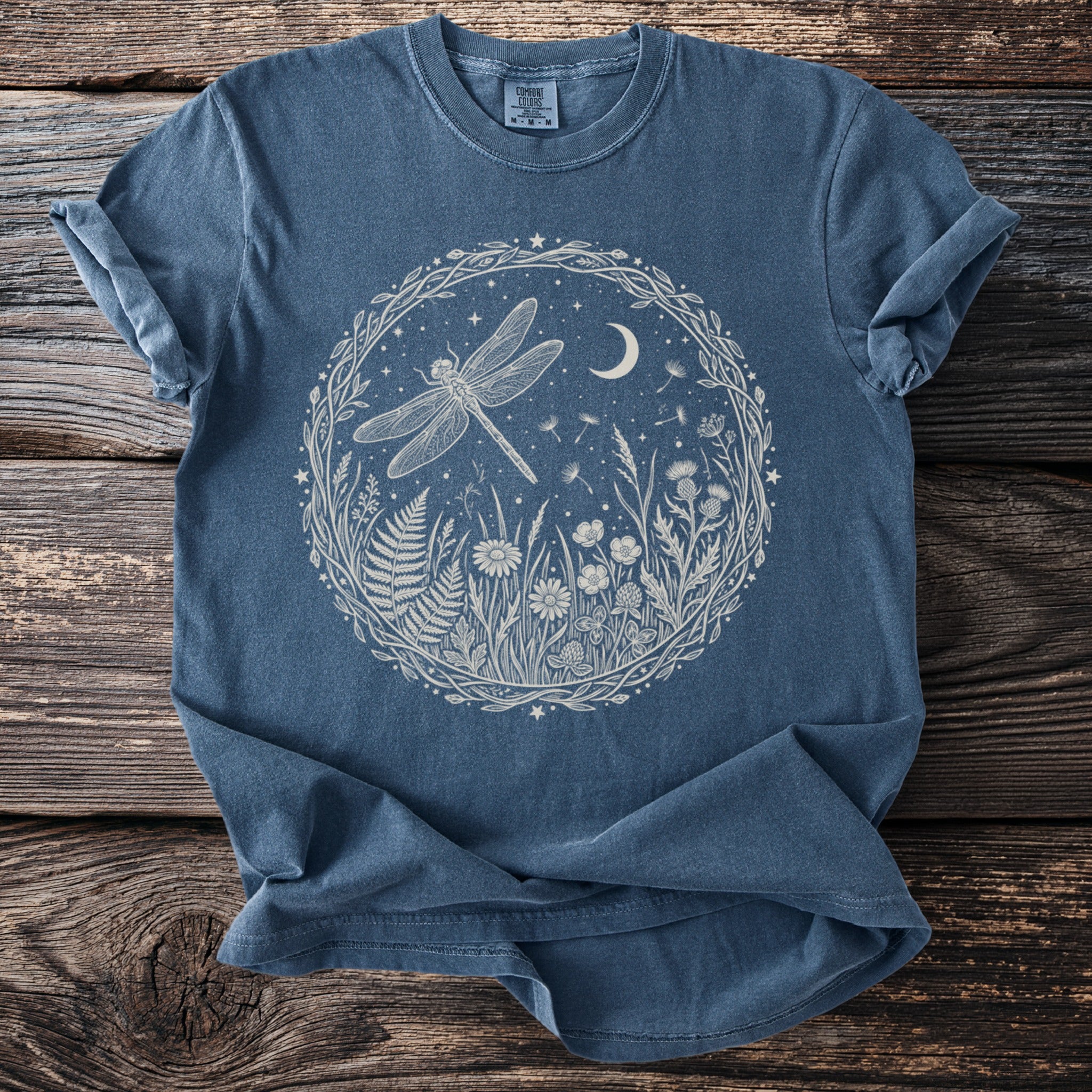 Denim t-shirt with a white circular nature design featuring a dragonfly and moon.