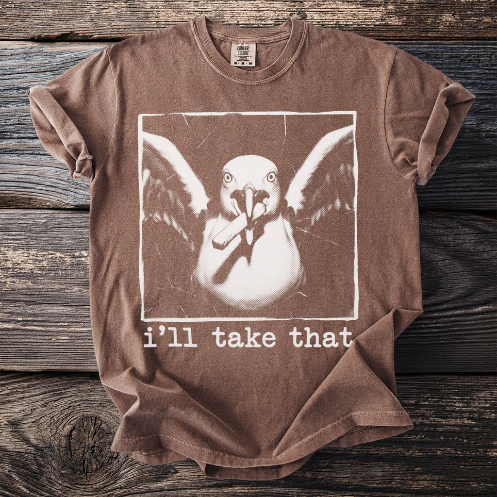 Brown t-shirt with a white graphic of a seagull holding chopsticks and the text "i'll take that".