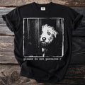 Black t-shirt graphic with distressed image of dog peeking through a door and text "please do not perceive r".
