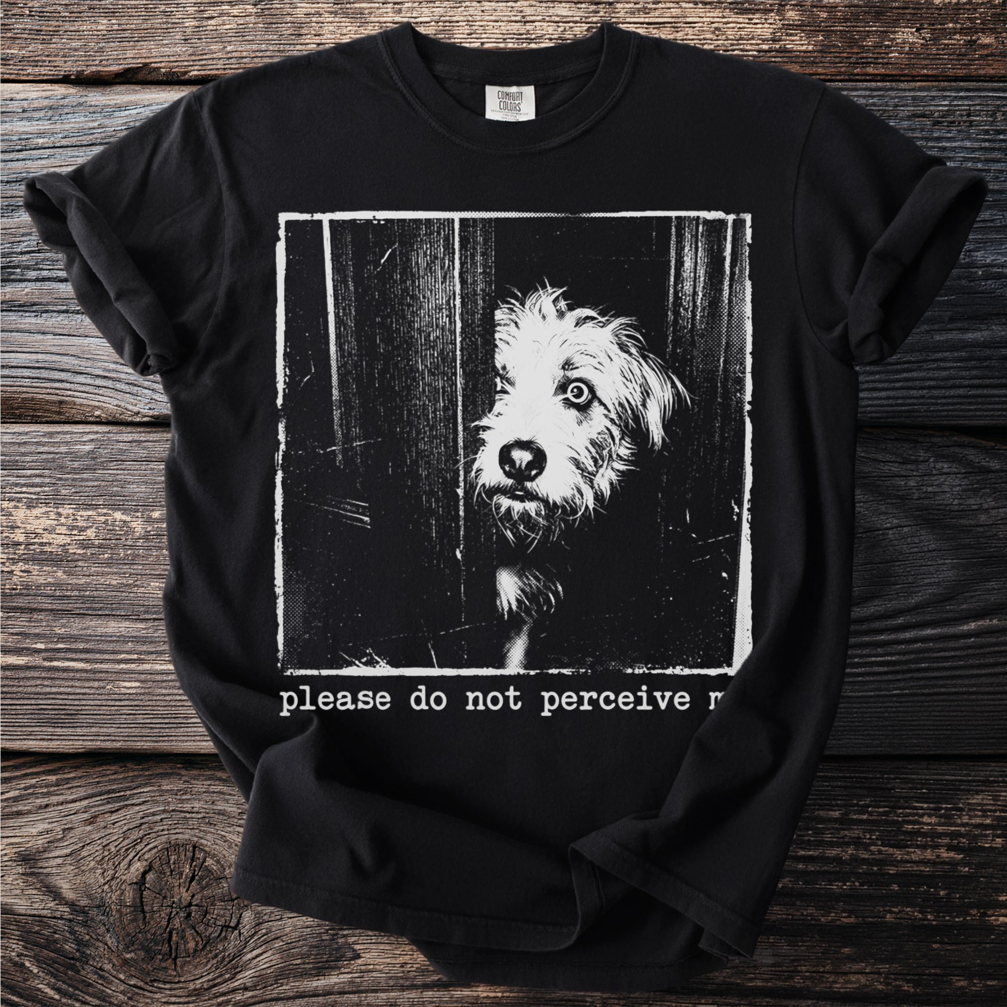 Black t-shirt graphic with distressed image of dog peeking through a door and text "please do not perceive r".