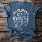 T-shirt with a white line drawing of the Headless Horseman holding a pumpkin and riding a horse.