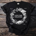 Black t-shirt with "LOVE THE UNLOVED" text surrounded by illustrations of animals.