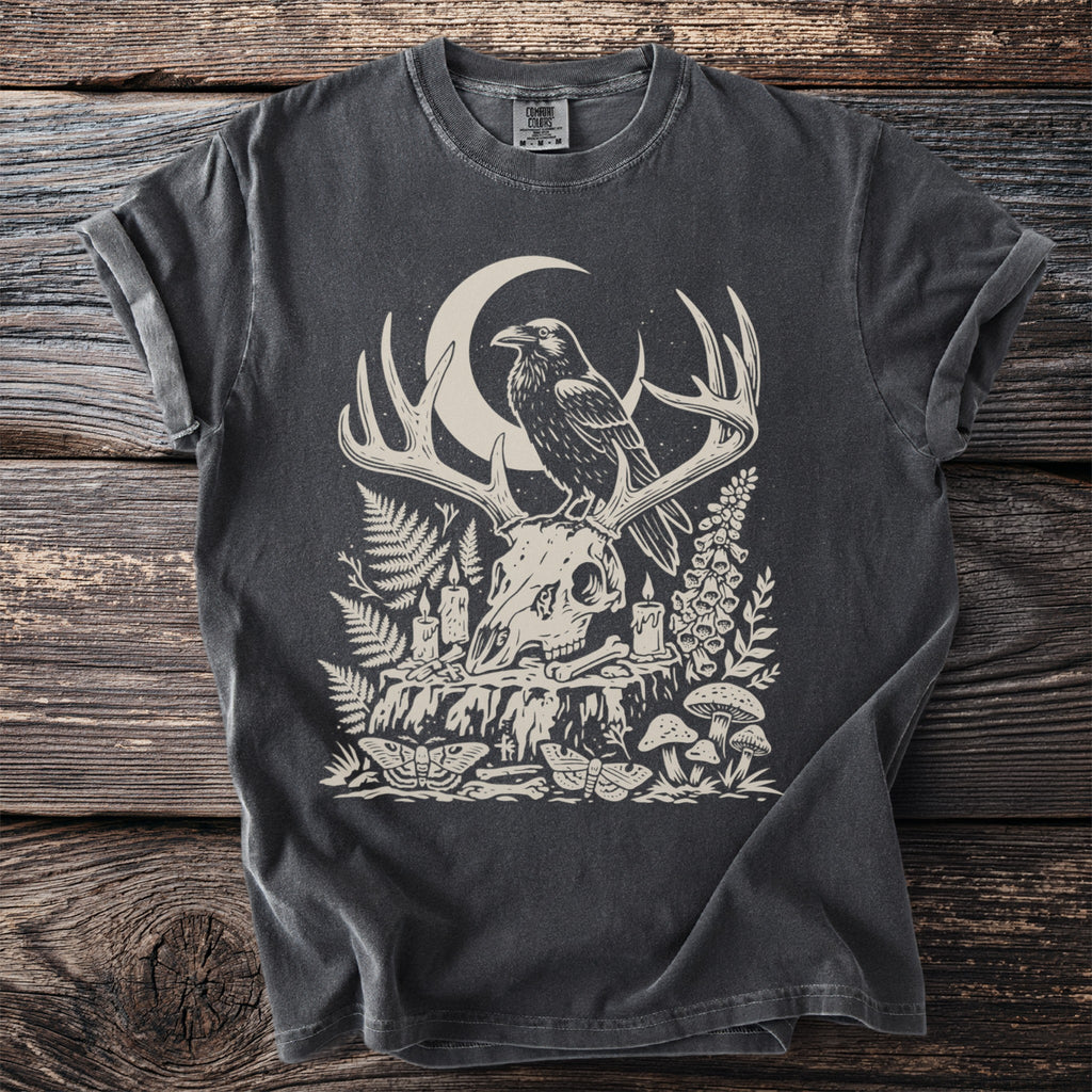 Dark grey t-shirt with a skull, antlers, raven, moon, and woodland art.