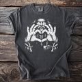 T-shirt with a graphic of a bearded man making a heart shape with his hands, two goats, and a hammer.
