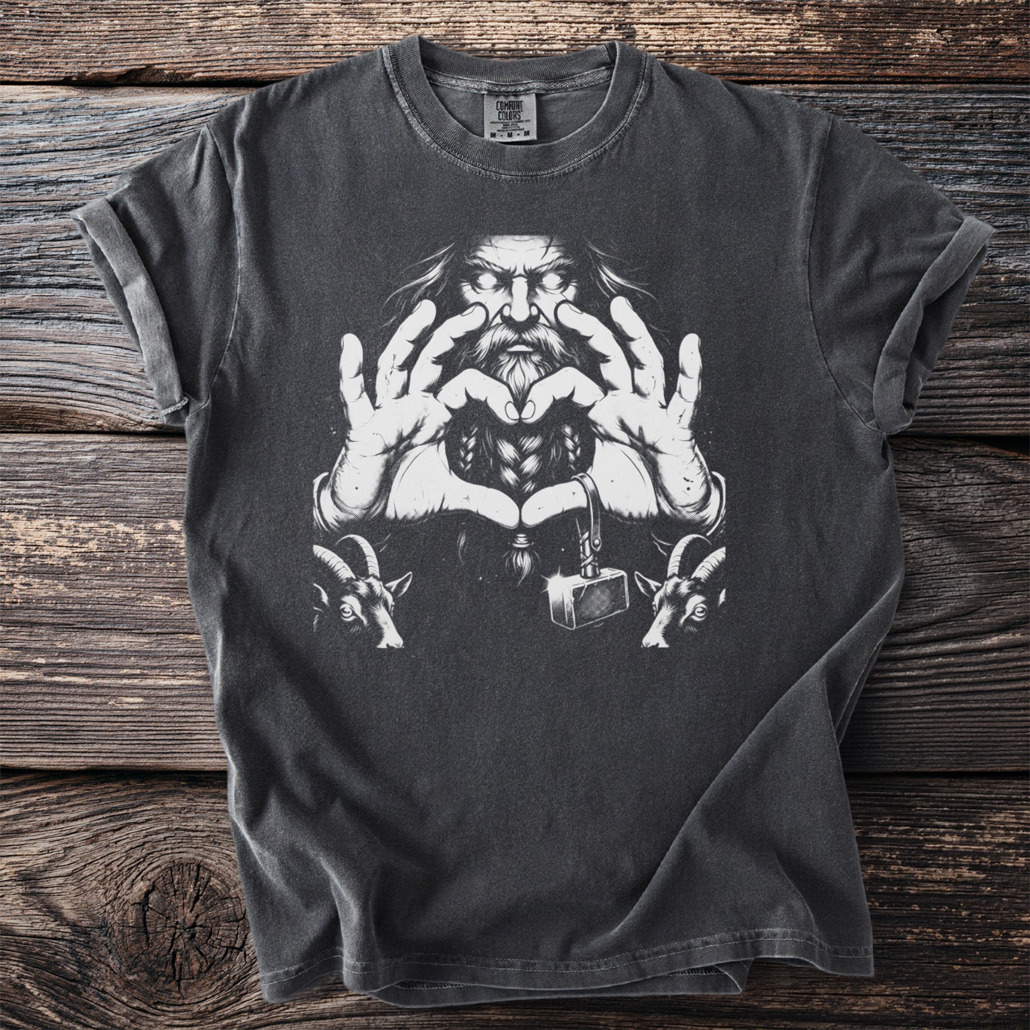 T-shirt with a graphic of a bearded man making a heart shape with his hands, two goats, and a hammer.