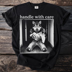 Black t-shirt with "handle with care" and wolf holding a kitten graphic.