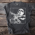 Black t-shirt with a graphic of a frog by a full moon in a forest.