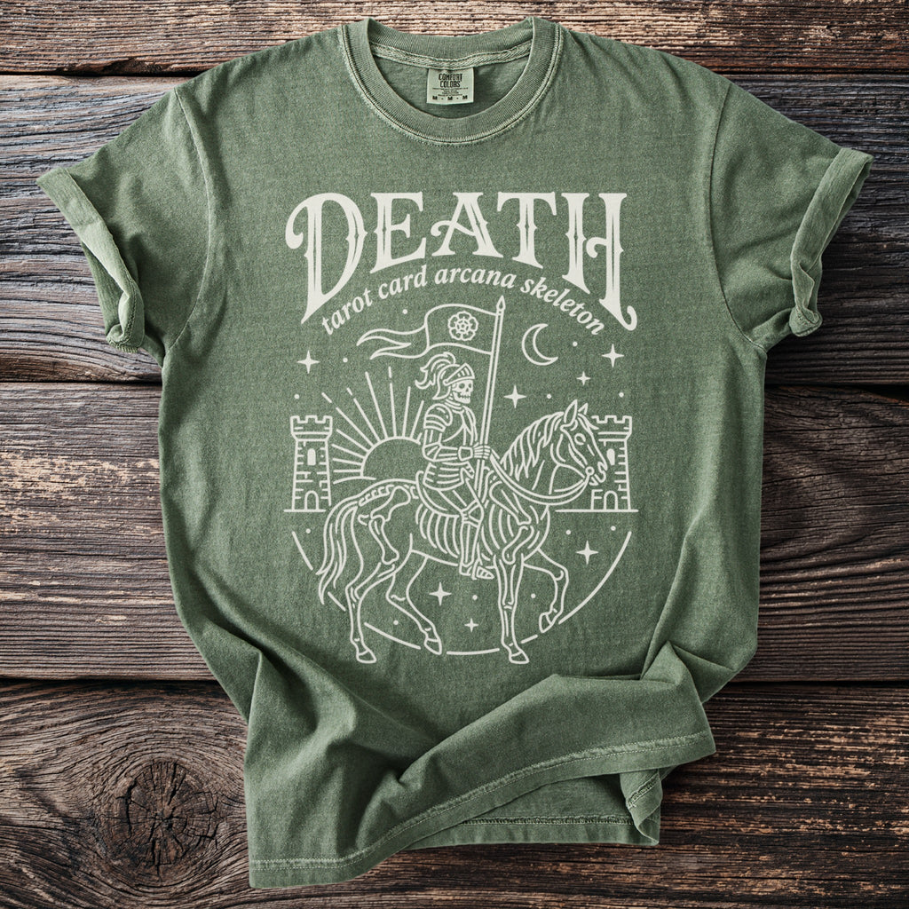 Green t-shirt with a white line drawing of a skeleton knight on a horse, with castles and stars.