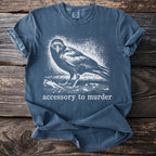 Blue t-shirt with white crow graphic and text Accessory to Murder