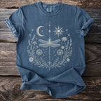 Blue t-shirt with a moon, sun, and dragonfly floral graphic.