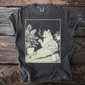 Line art of a cat smoking and drinking among plants and cans on a t-shirt.