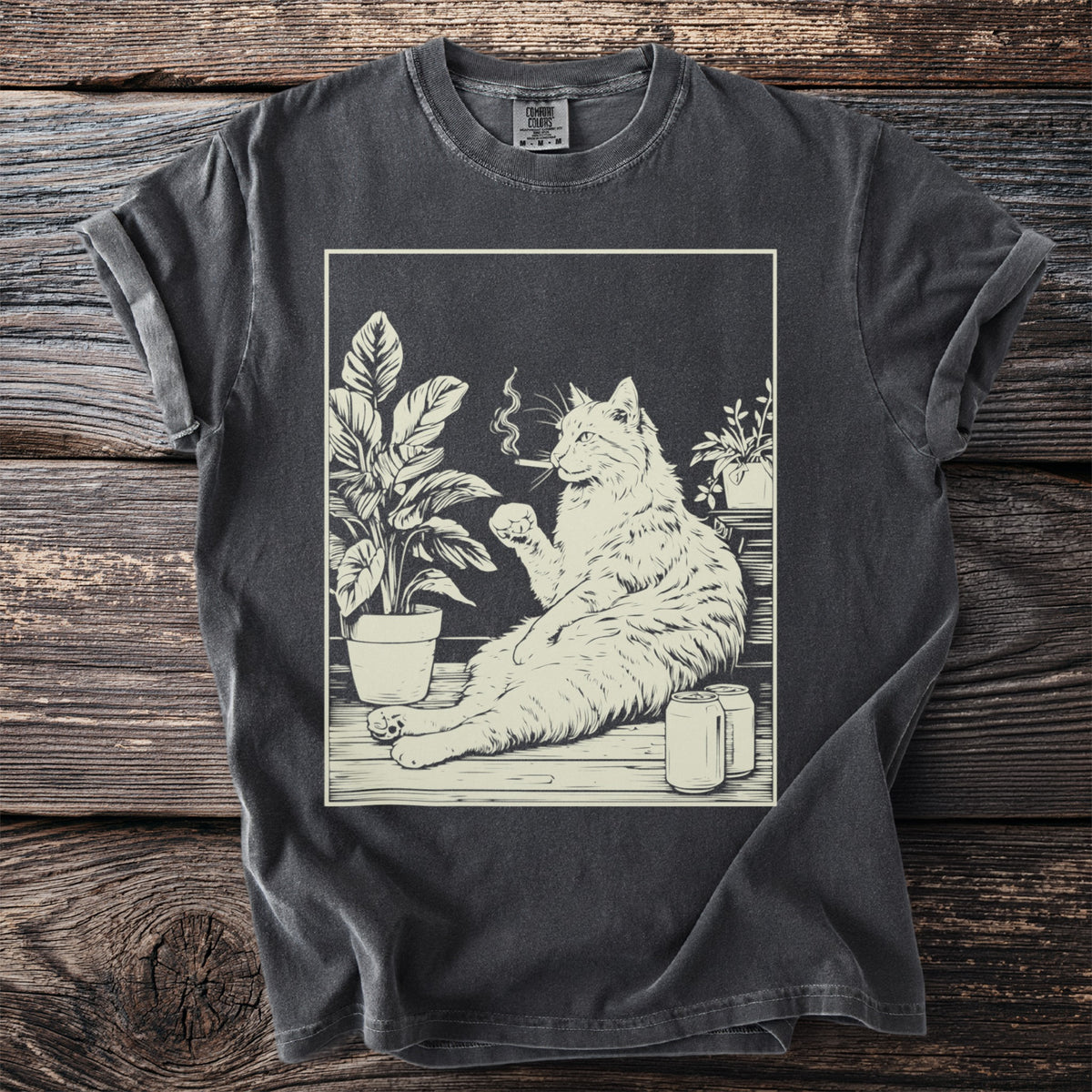 Line art of a cat smoking and drinking among plants and cans on a t-shirt.
