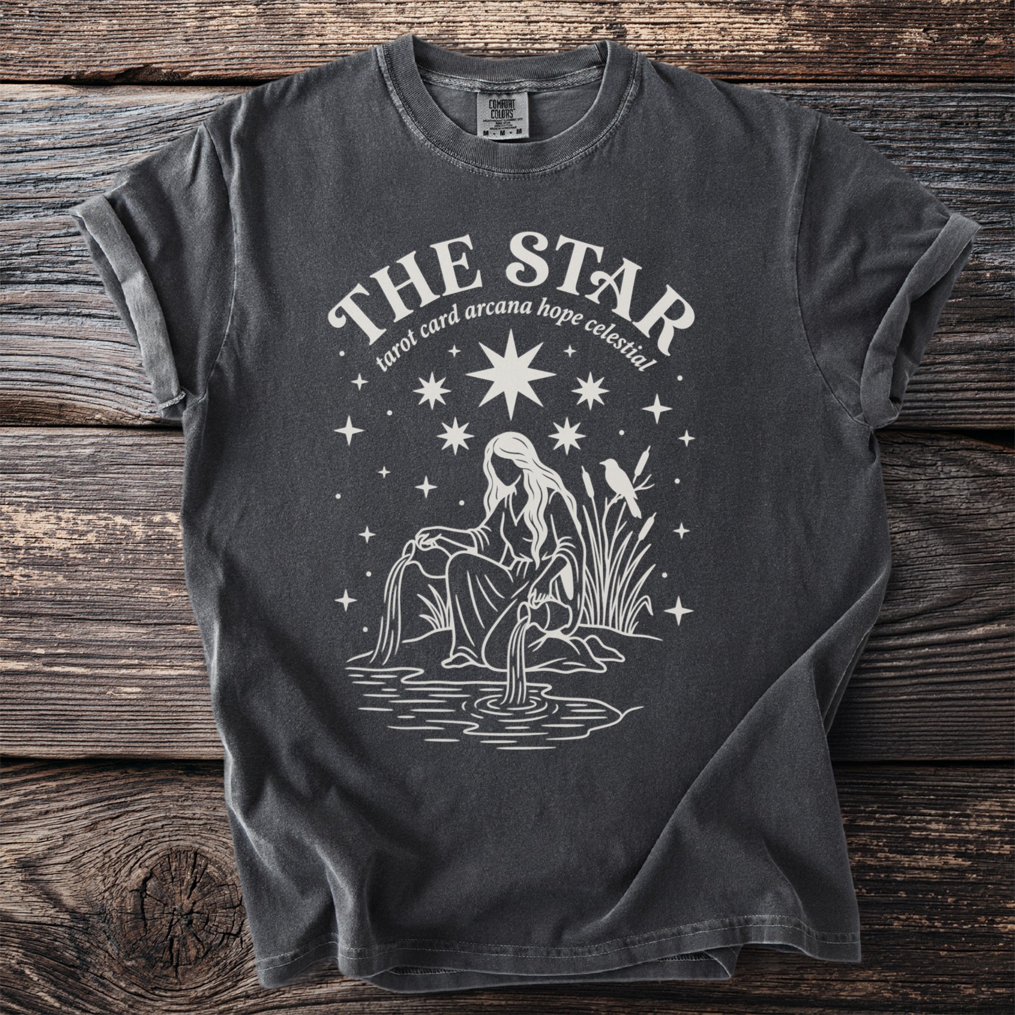 Dark gray t-shirt with "The Star tarot card arcana hope celestial" and tarot imagery.