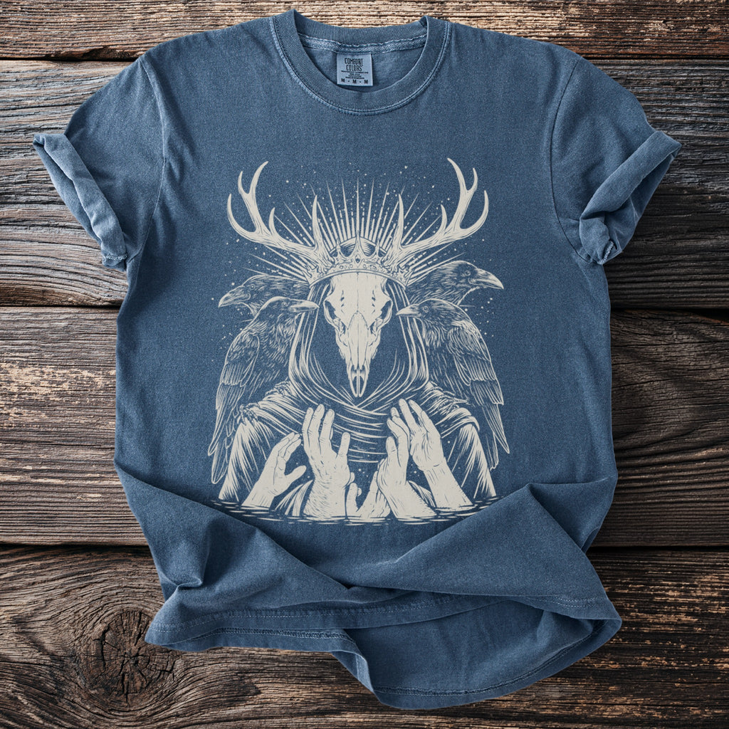 Blue t-shirt with a cream skull, antlers, crown, and ravens design.