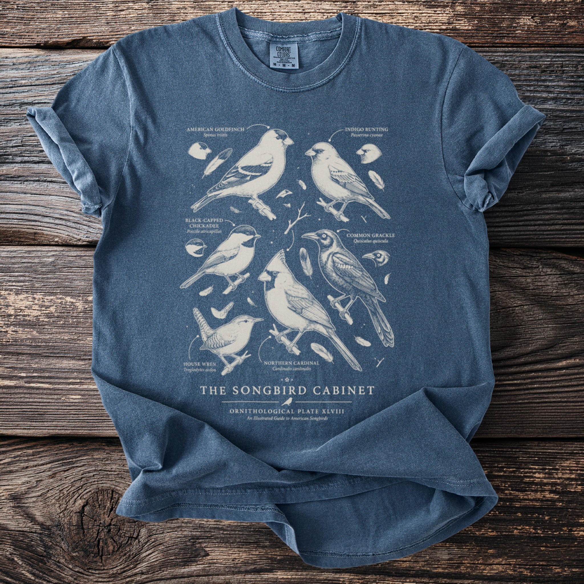 T-shirt with vintage illustration of six songbirds and text "THE SONGBIRD CABINET".
