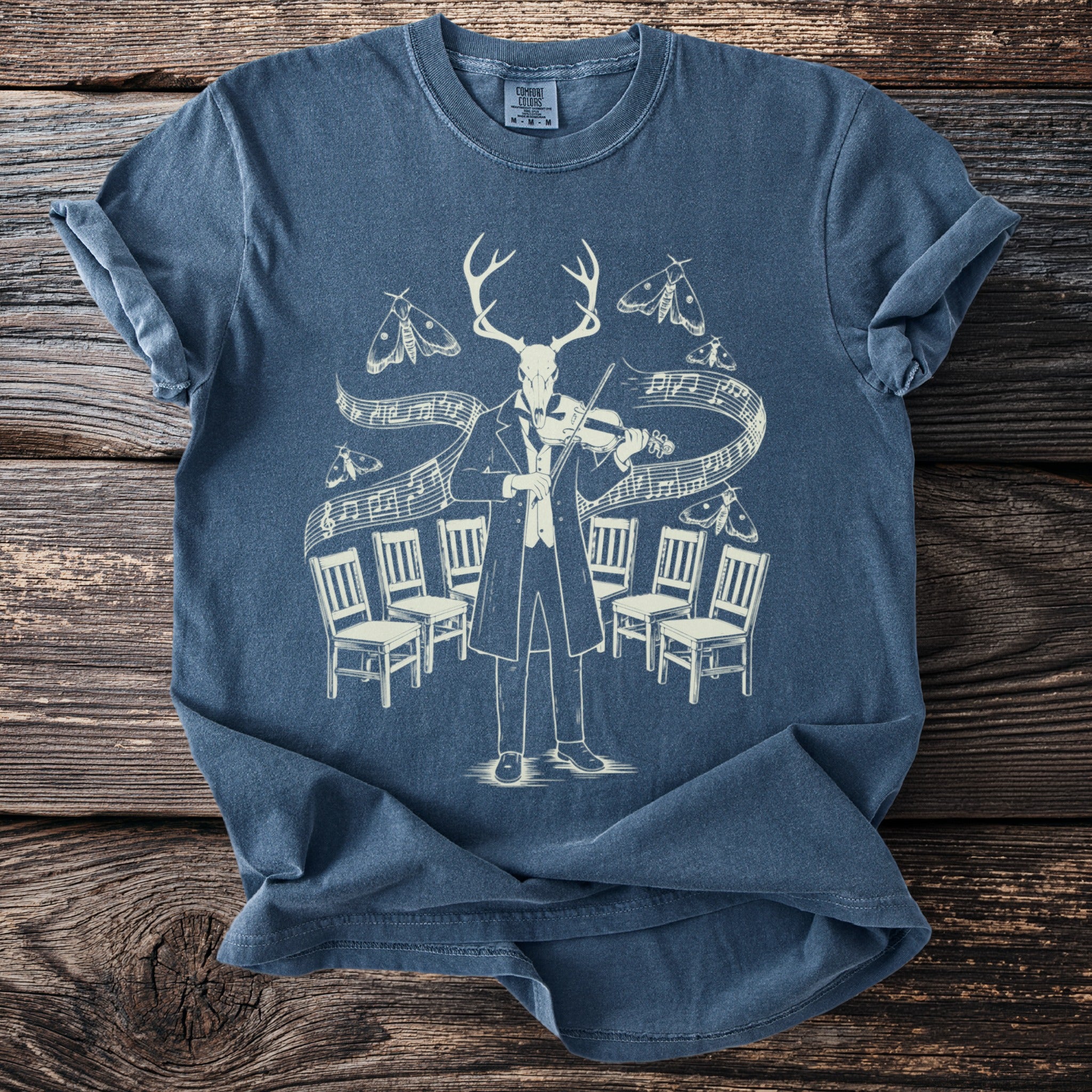 Deer skull man playing violin surrounded by moths and chairs on musical notes.