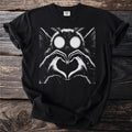 Black t-shirt with a graphic of a moth with glowing eyes making a heart shape.