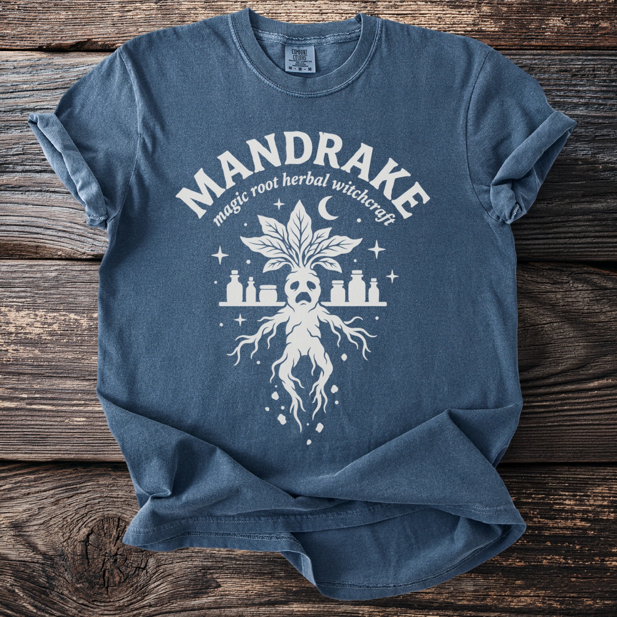 Blue t-shirt with white MANDRAKE graphic, magic root herbal witchcraft, and mandrake plant.