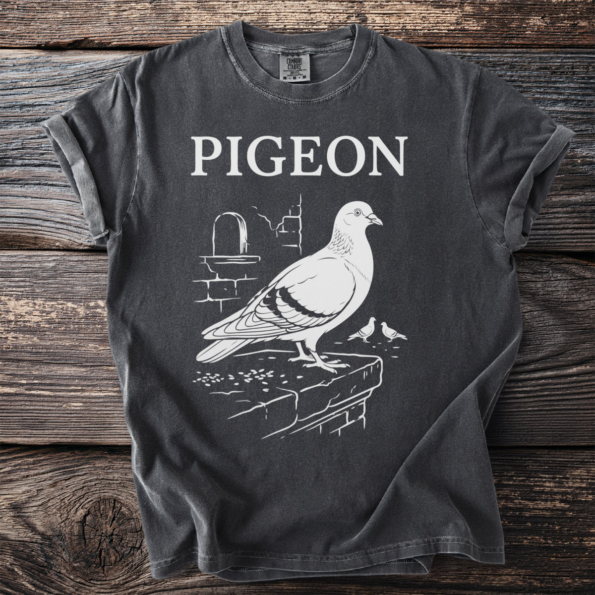 Dark grey t-shirt with white text "PIGEON" and a pigeon graphic.