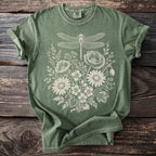 Green t-shirt with white dragonfly and floral line art graphic.