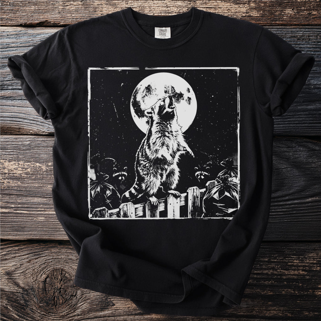 Black t-shirt with graphic of a raccoon howling at the moon on a fence.