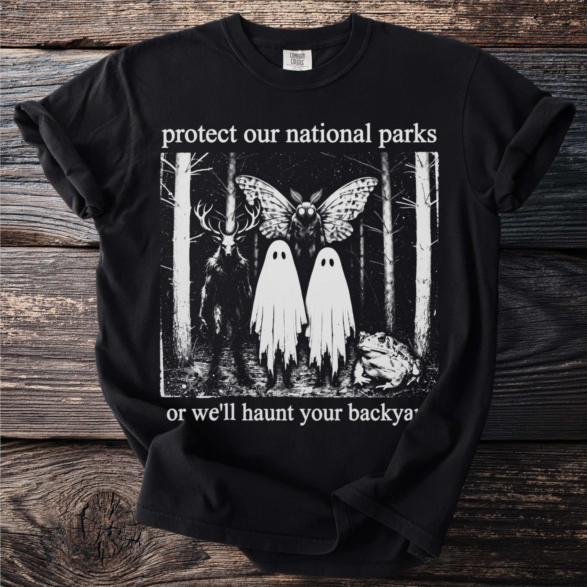 Black t-shirt with "protect our national parks" and spooky forest creatures.