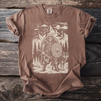 Brown t-shirt with a graphic of a bear warrior, wolf, and mountains.
