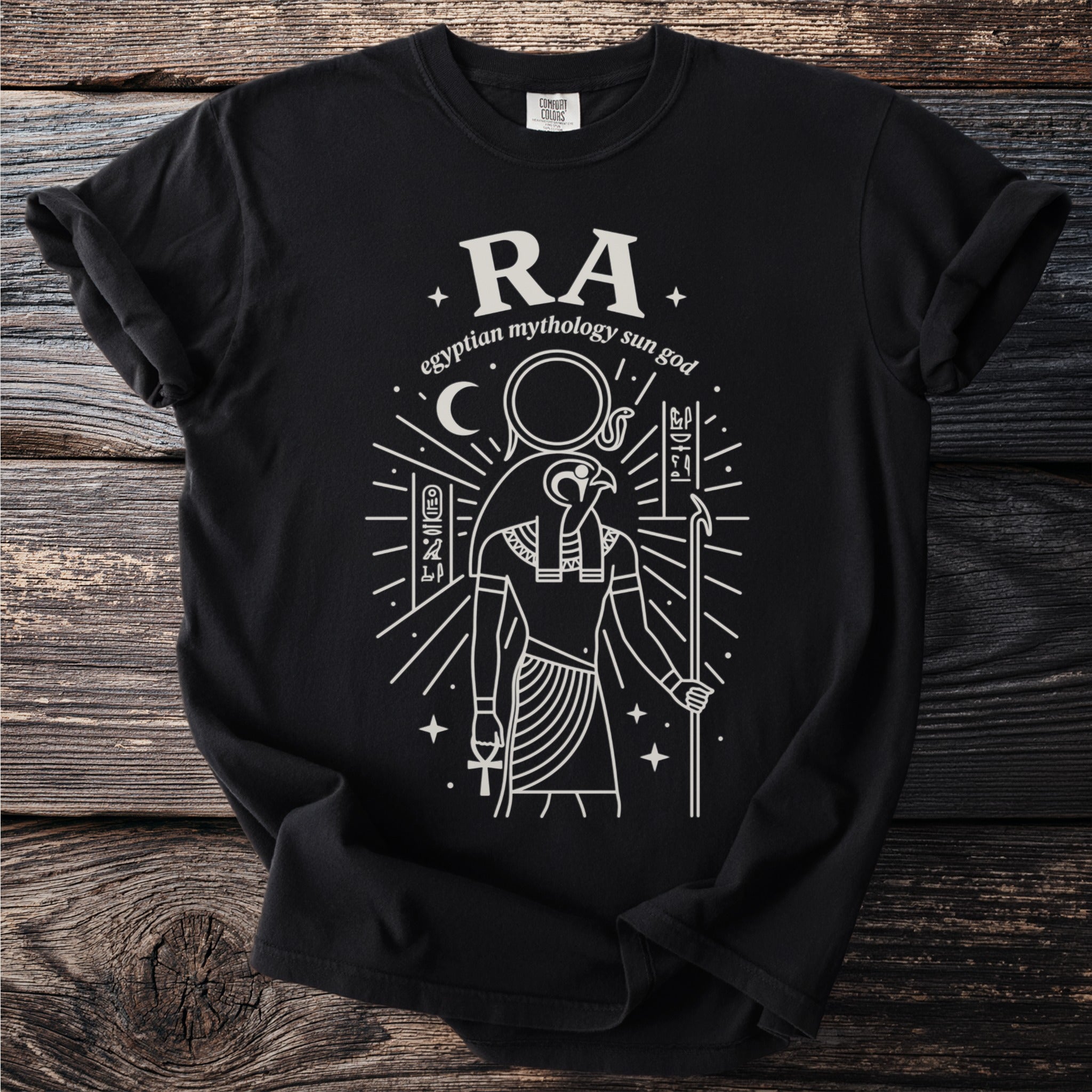 Black t-shirt with line art of Ra, Egyptian sun god, and hieroglyphs.