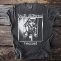 T-shirt with black and white graphic of a wolf in clothes and text "built different (worse)".