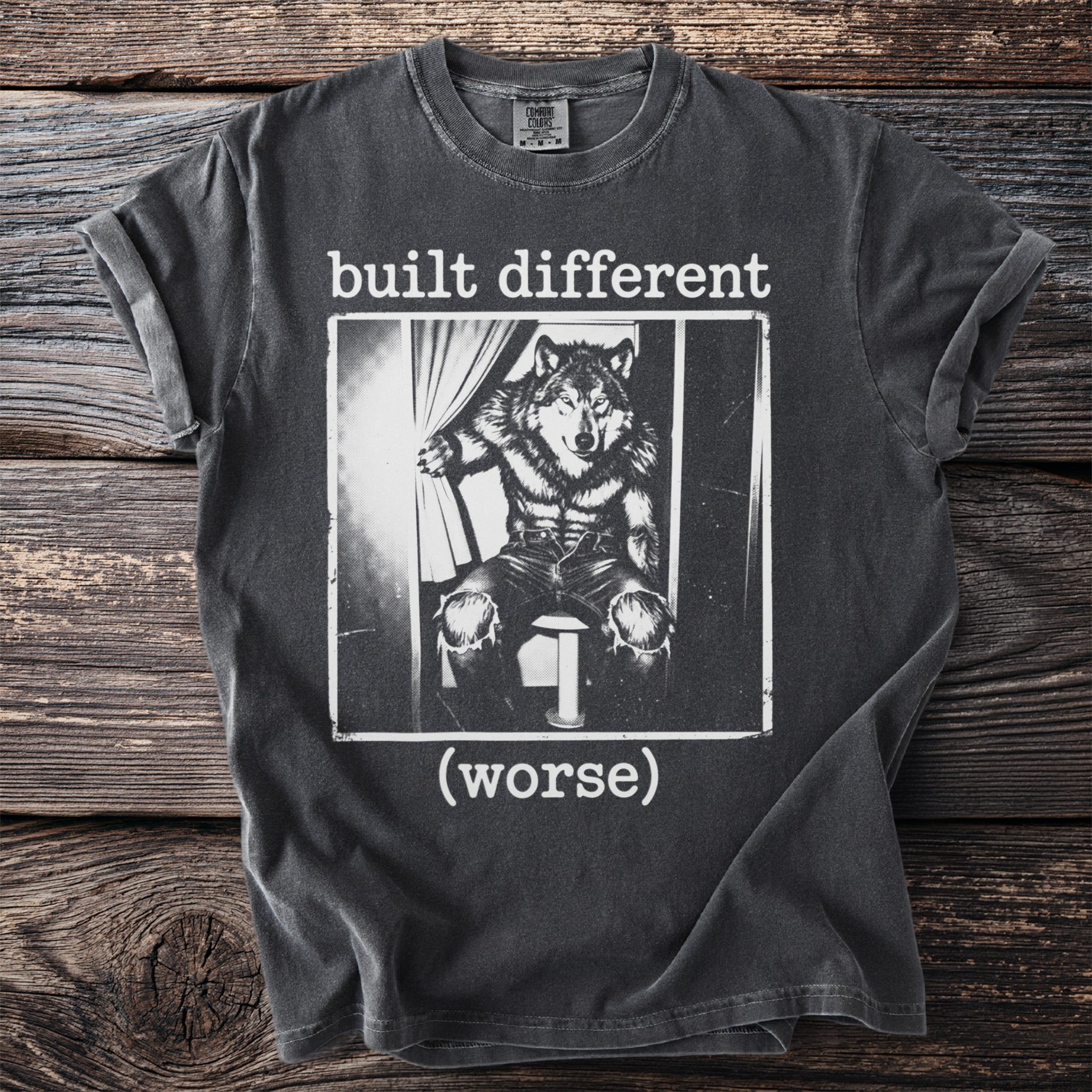 T-shirt with black and white graphic of a wolf in clothes and text "built different (worse)".