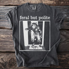 Dark grey t-shirt with text "feral but polite" and werewolf graphic.
