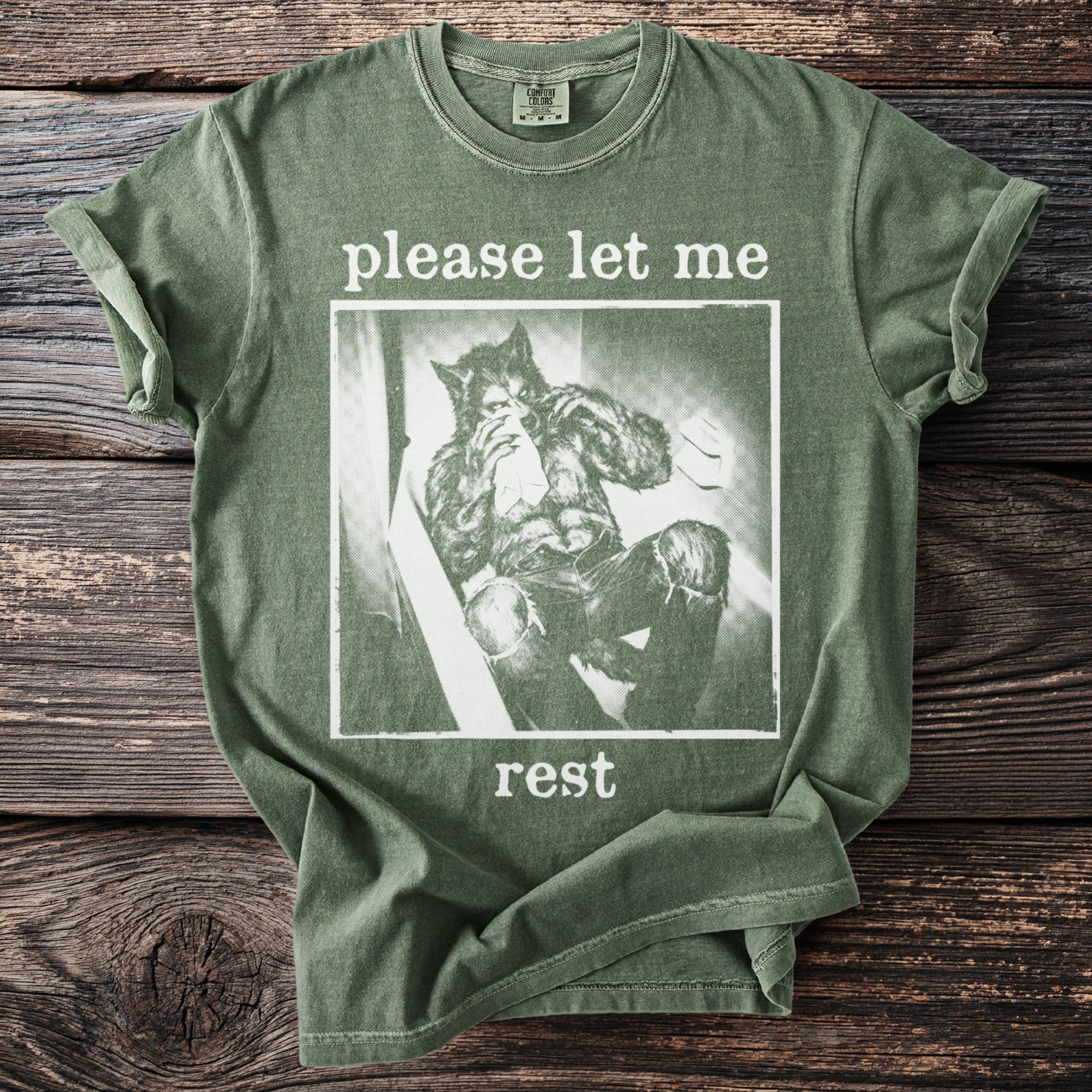 Olive green t-shirt with werewolf graphic and text "please let me rest."