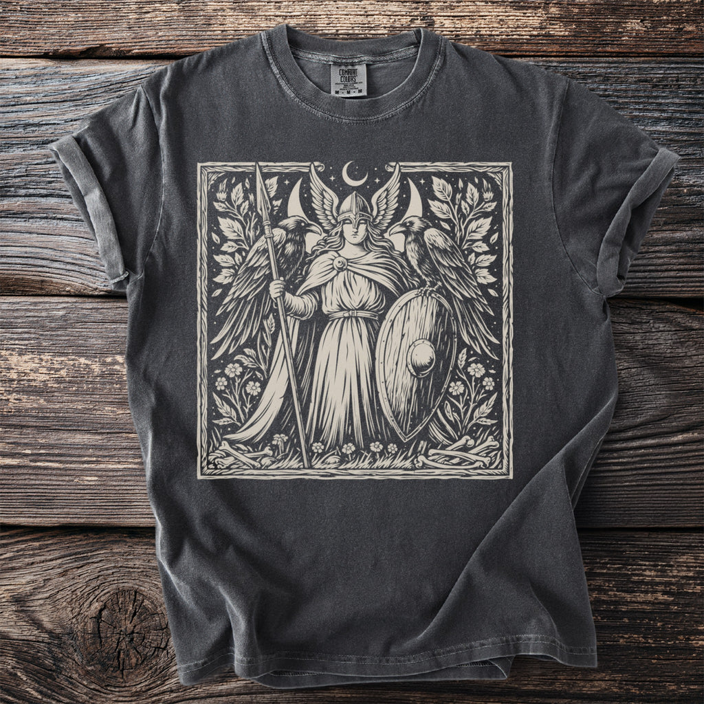 Valkyrie with shield and spear, flanked by ravens, beneath a crescent moon.