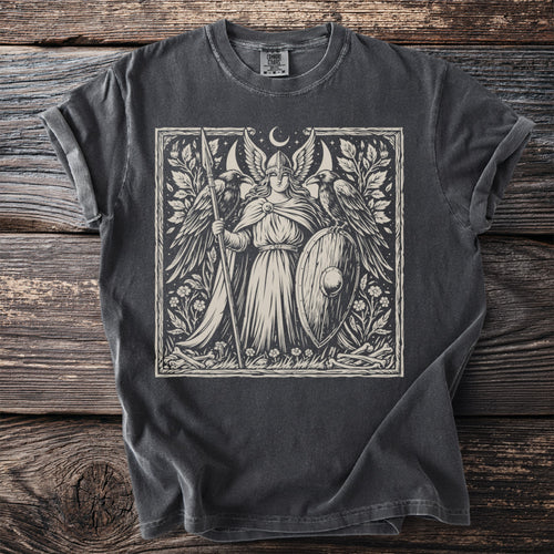 Valkyrie with shield and spear, flanked by ravens, beneath a crescent moon.
